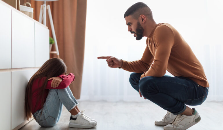 Family Conflict. Angry father scolding sad daughter